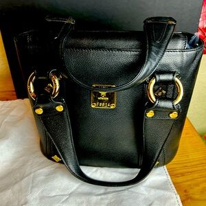 This MCM Shoulder Bag in Black Leather and Gold Hardware and dustcover